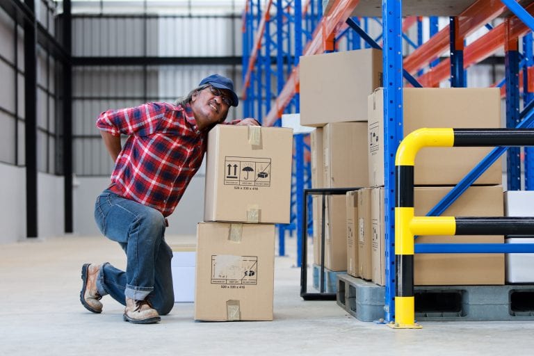 Work injury - worker man hurt his back .lift heavy box in factory